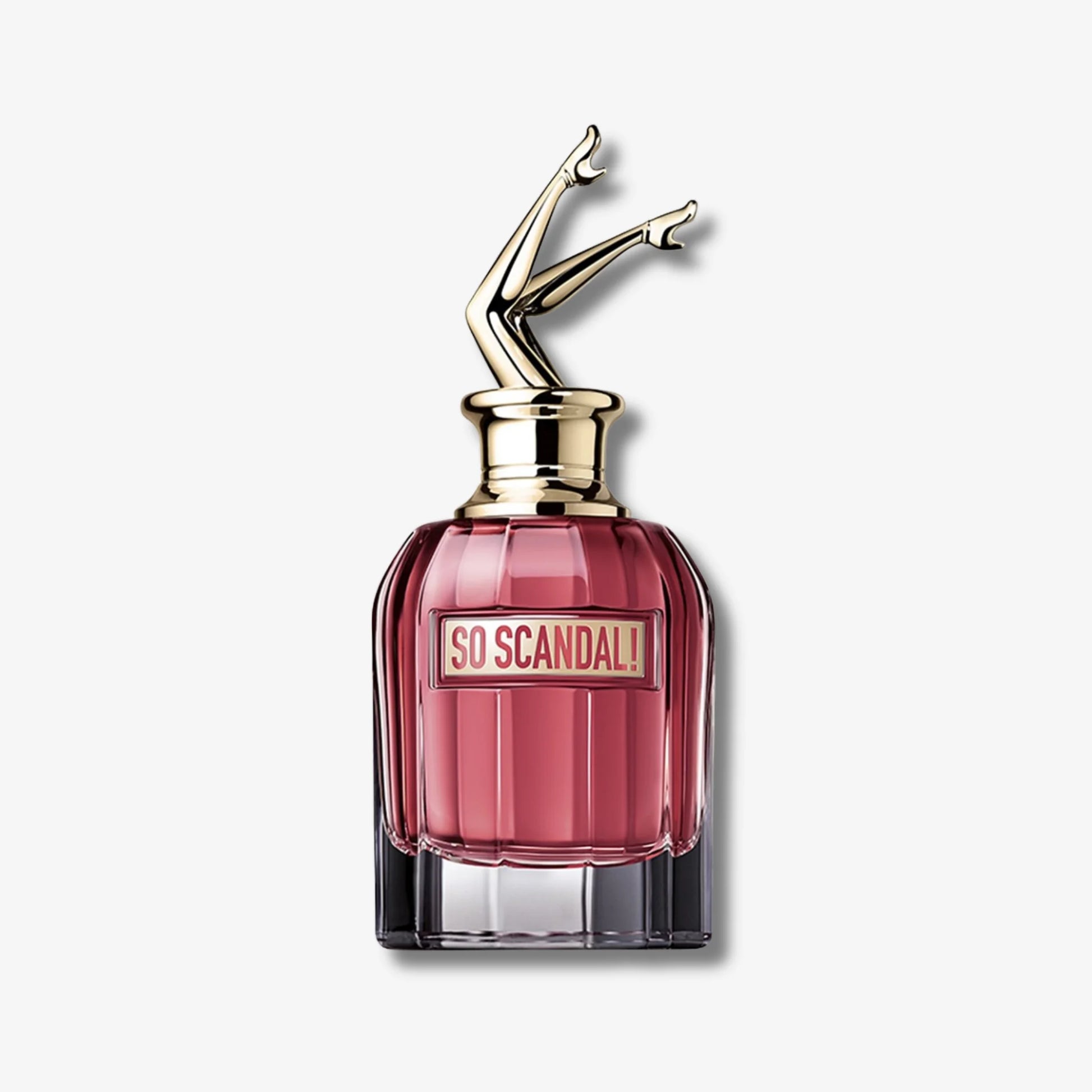 Perfume bottle labeled 'So Scandal' with a gold cap on a light gray background