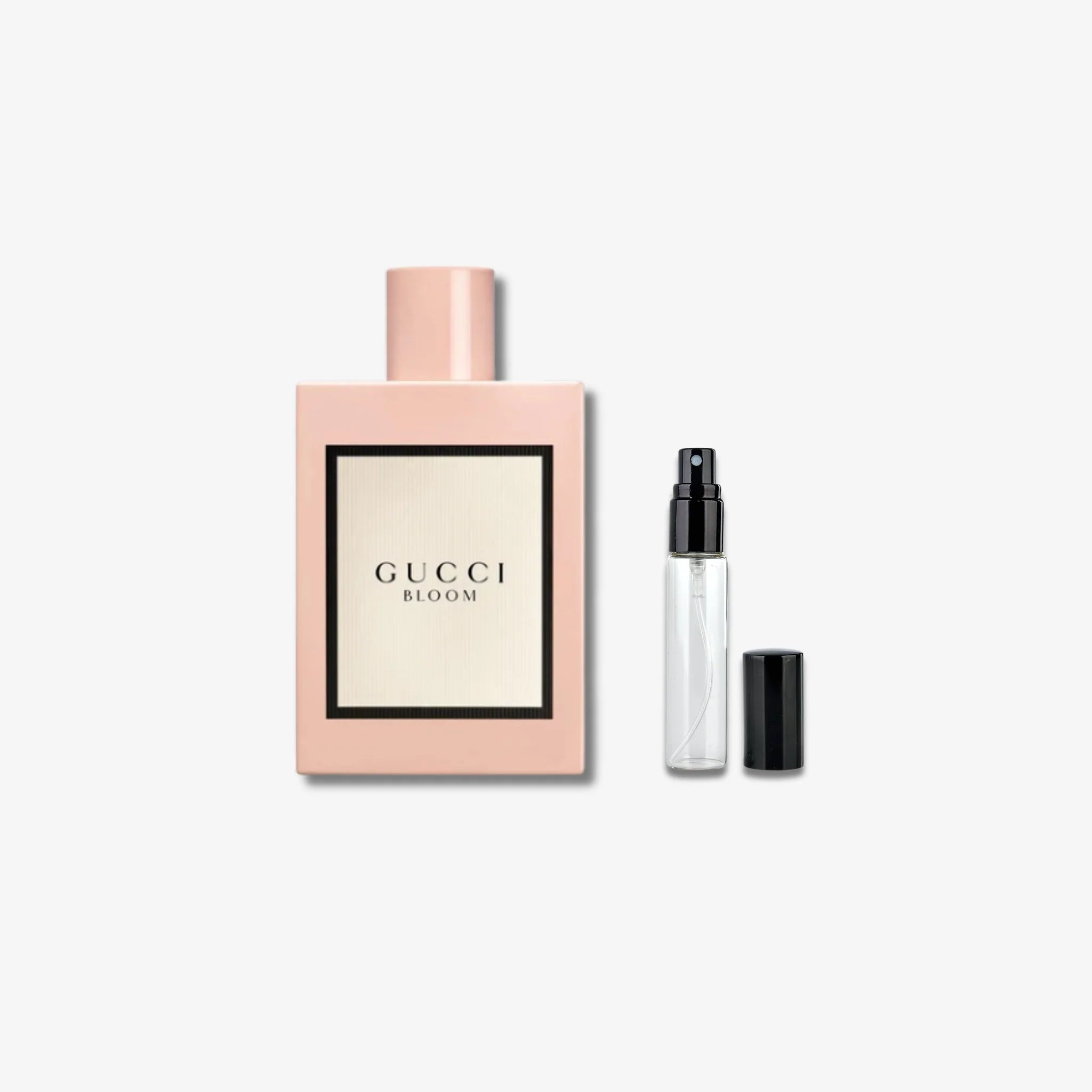 Gucci Bloom perfume set with a large bottle and a smaller travel-sized version on a light gray background