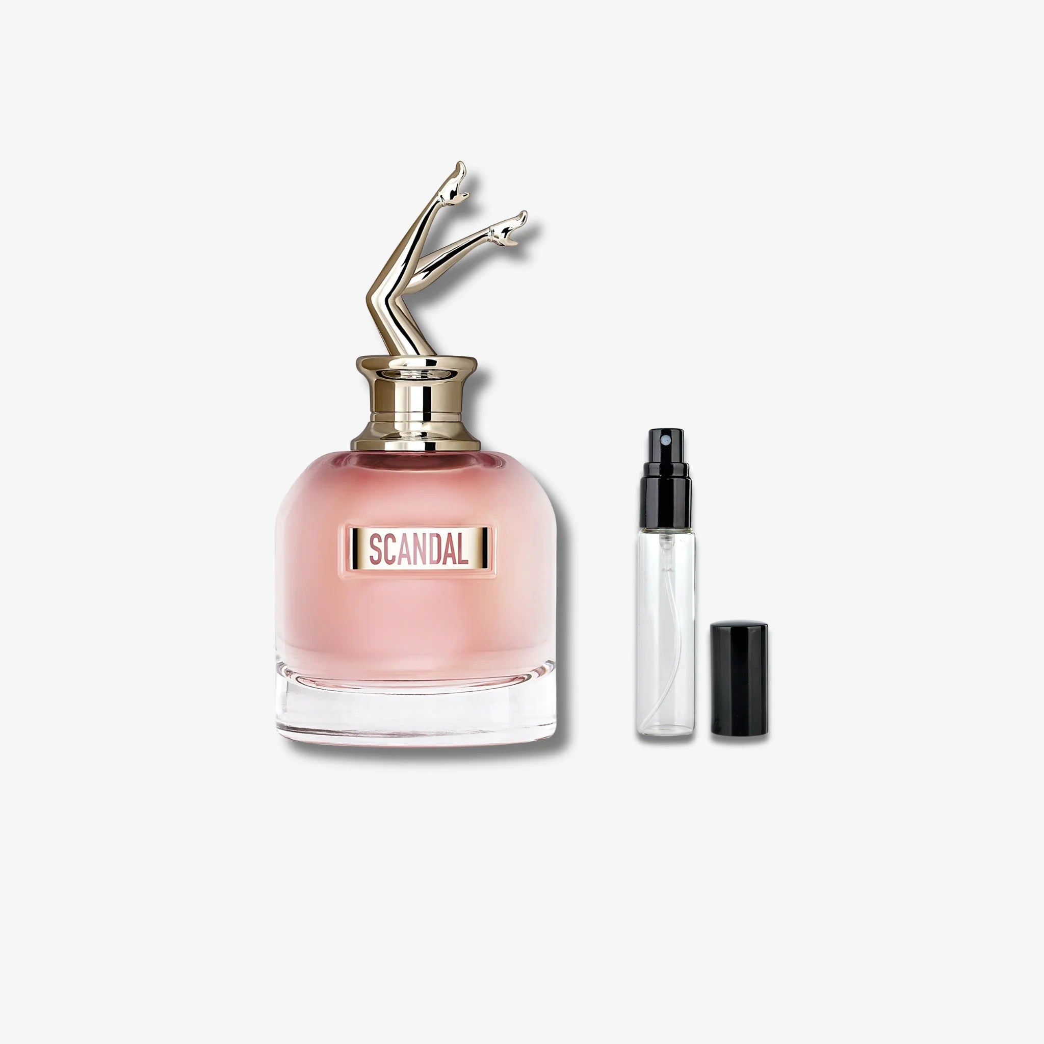 Jean paul gaultier scandal Perfume bottle with a smaller travel-sized version on a light gray background