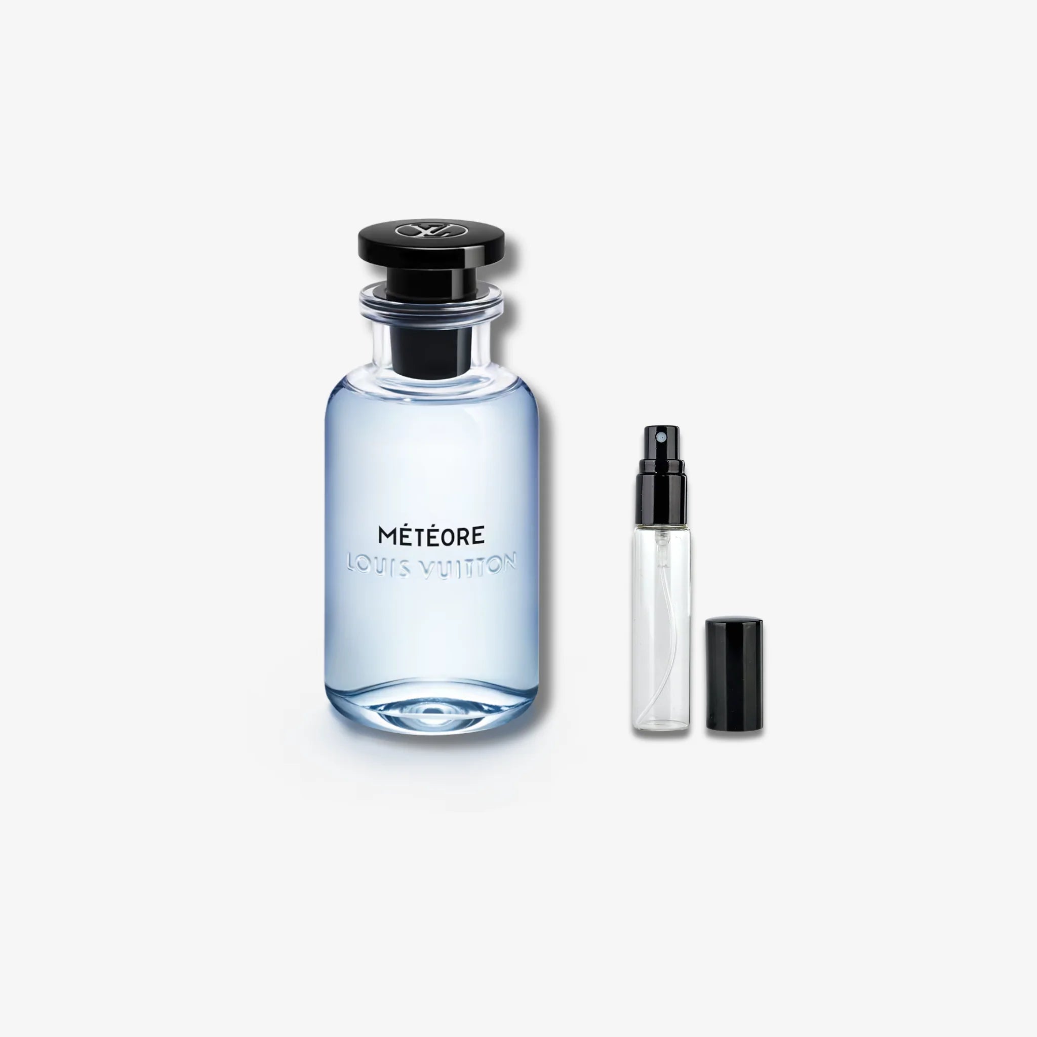 Louis Vuitton meteore perfume bottle and smaller spray bottle on a white background