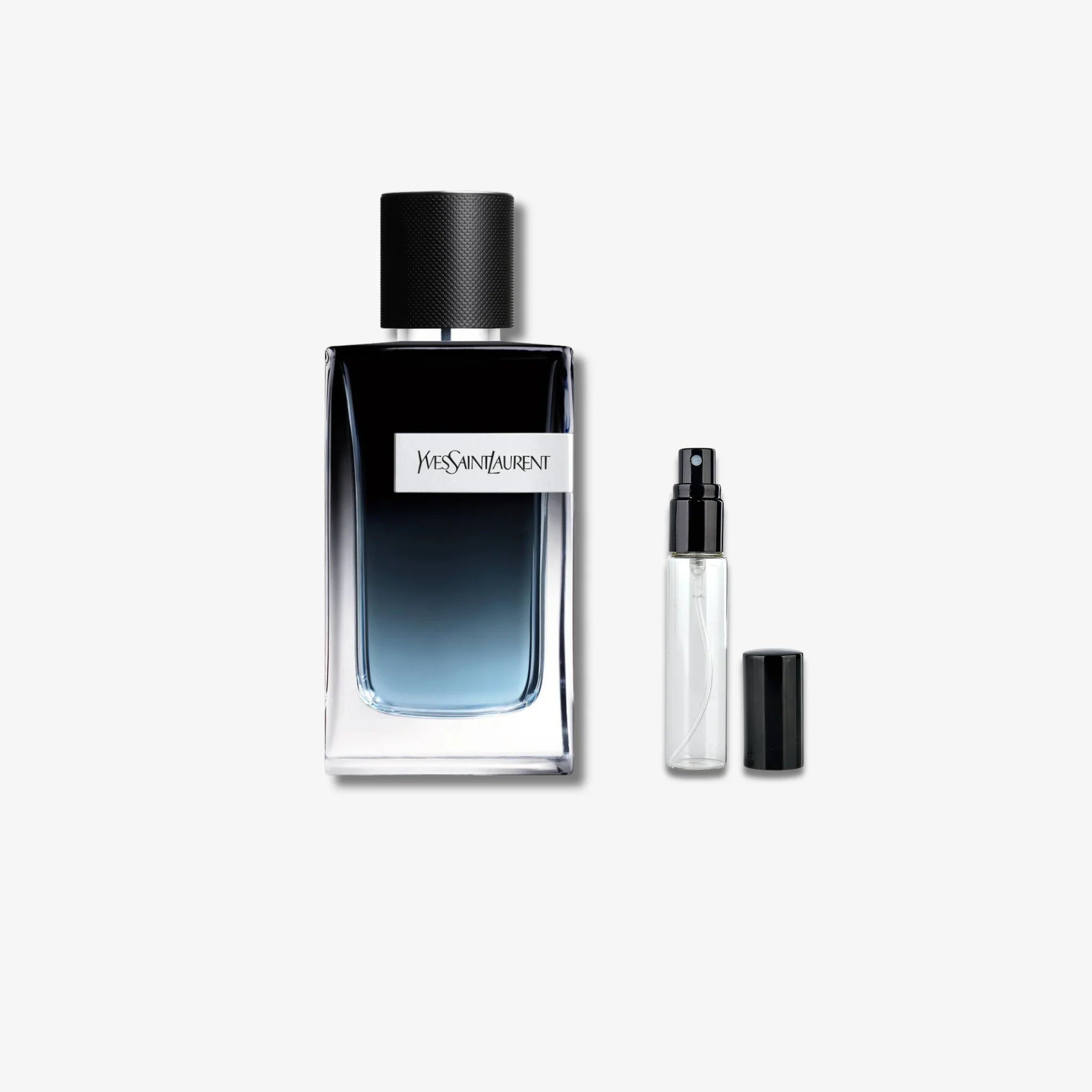 Yves Saint Laurent perfume bottle with smaller spray bottle on a white background